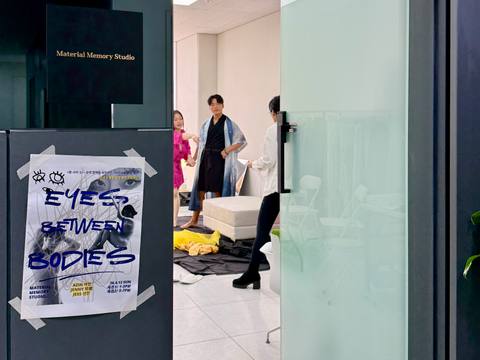 Eyes Between Bodies poster at the studio entrance