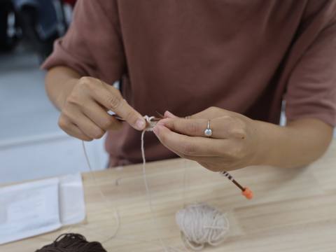 Participant casting on stitches during the workshop