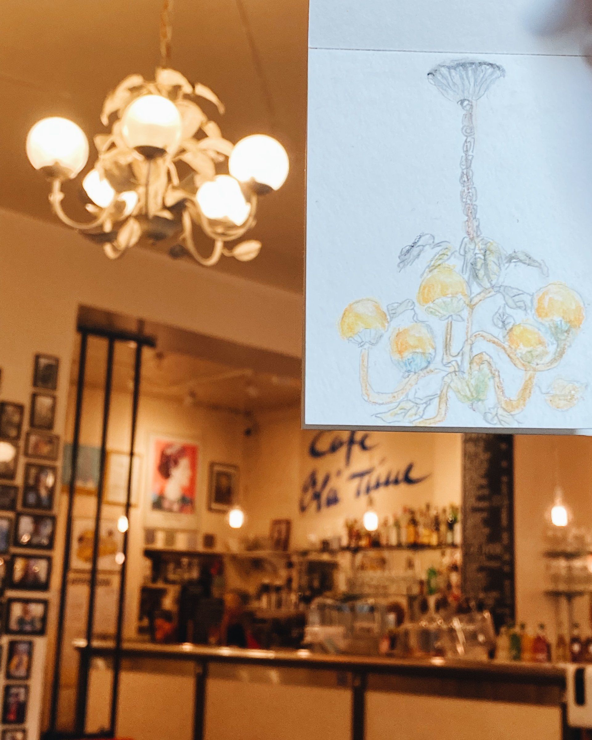 Watercolor sketch of a chandelier drawn inside a café