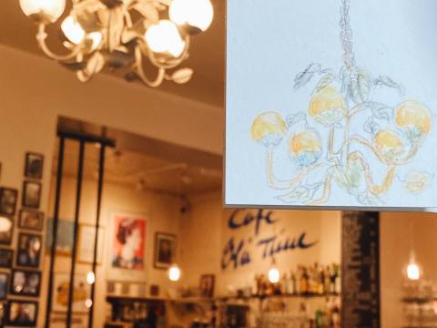 Watercolor sketch of a chandelier drawn inside a café