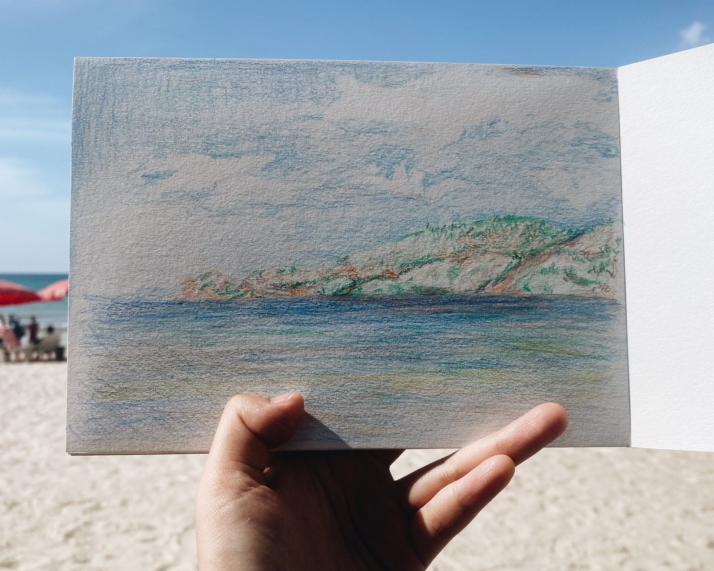 Colored pencil seascape drawn on the beach