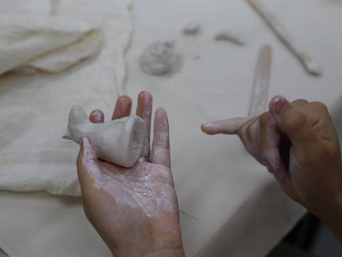 A small clay piece in hand — Material Lab × AI Archiving, July 8, 2026