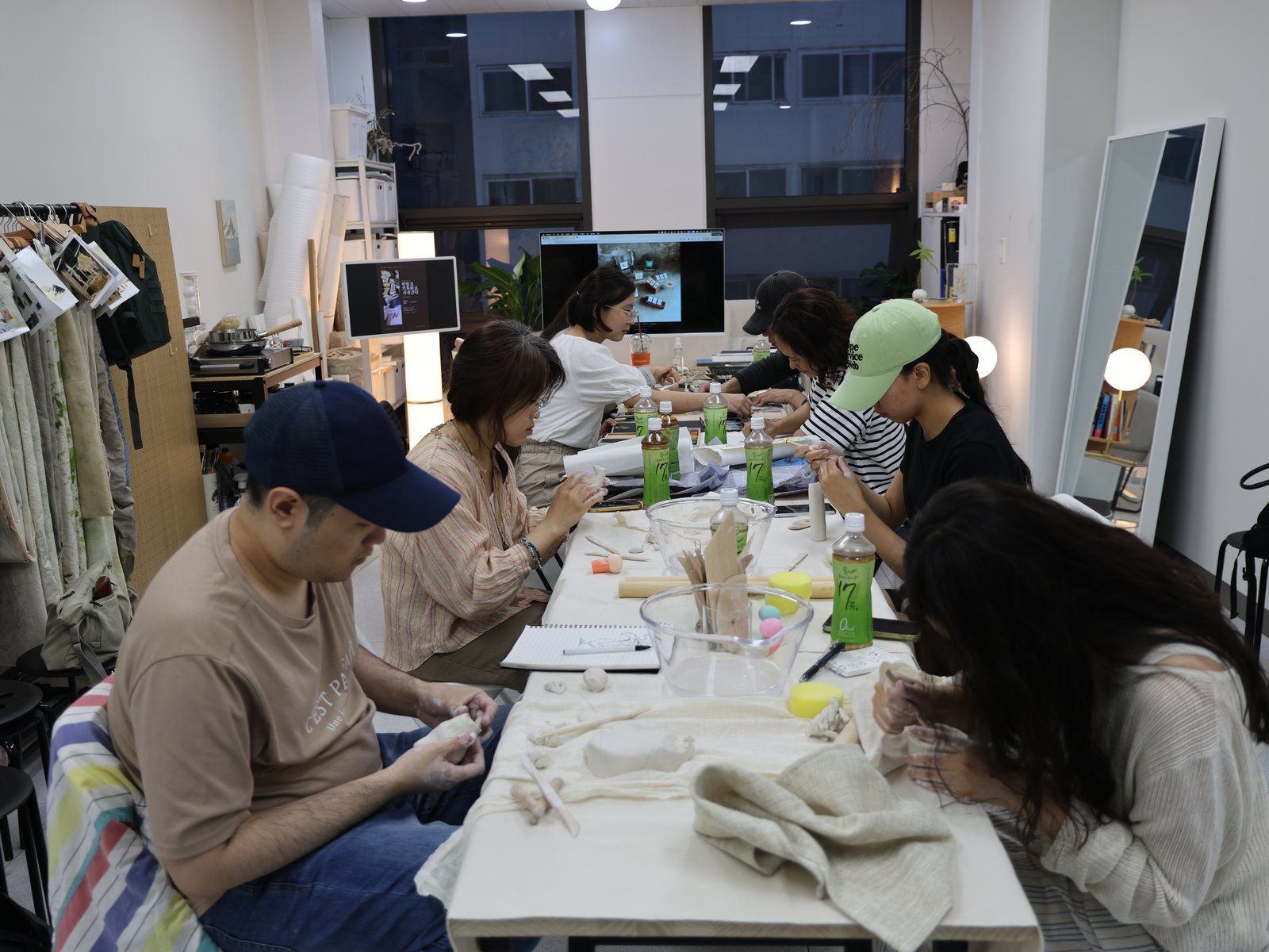 Participants shaping clay together — Material Lab × AI Archiving, July 8, 2026