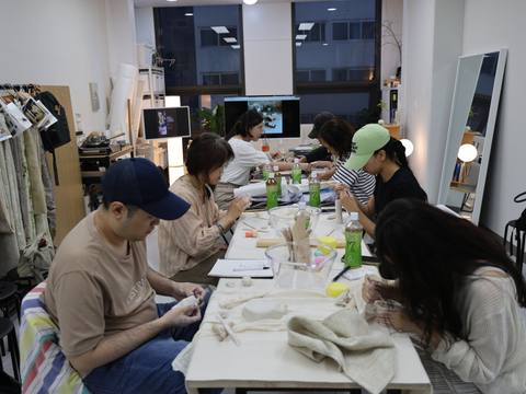 Participants shaping clay together — Material Lab × AI Archiving, July 8, 2026