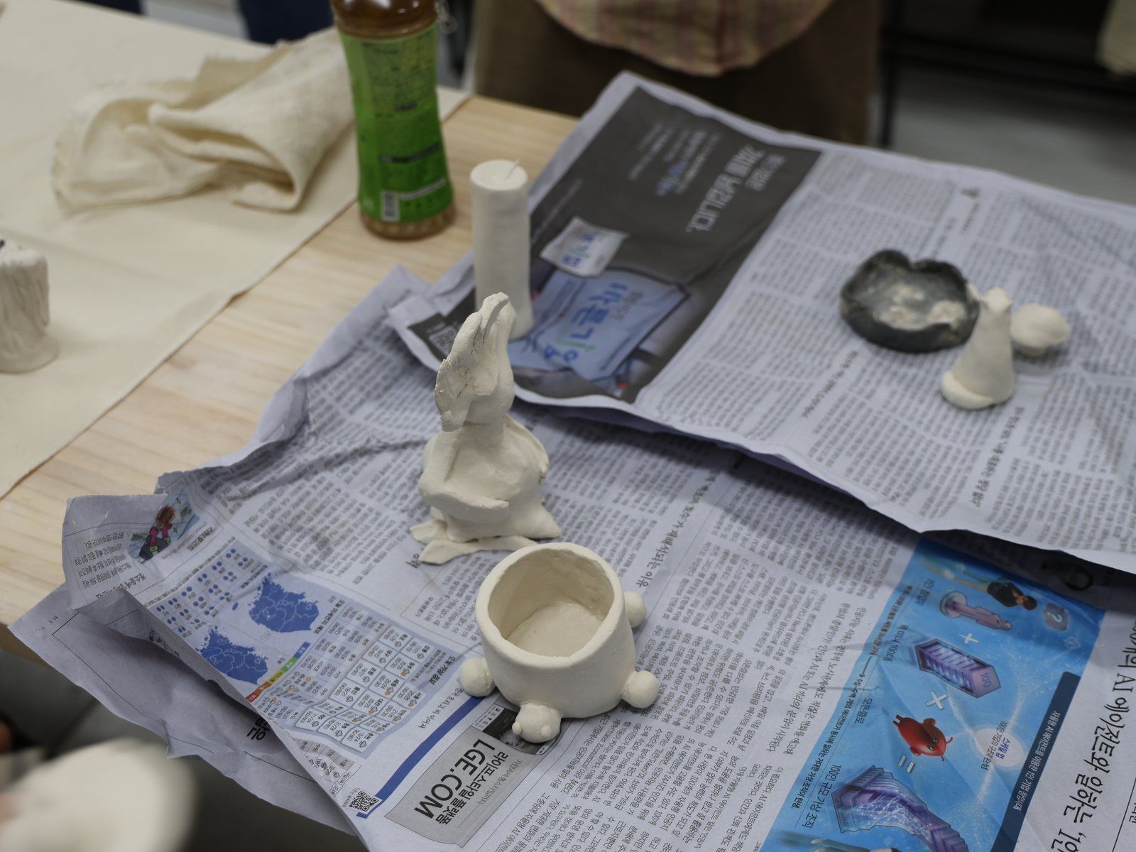 Small ceramic vessels and figures — Material Lab × AI Archiving, July 8, 2026