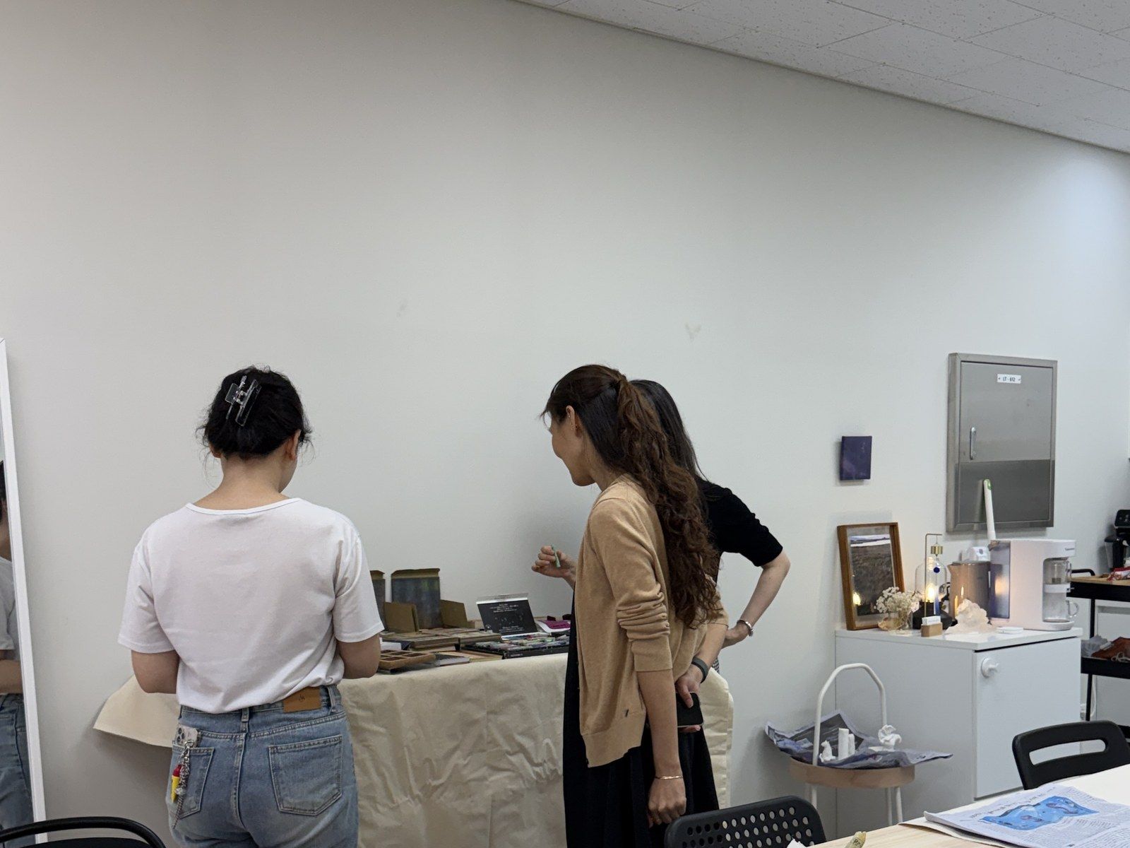 Participants looking over the materials table — Material Lab × AI Archiving, July 15, 2026