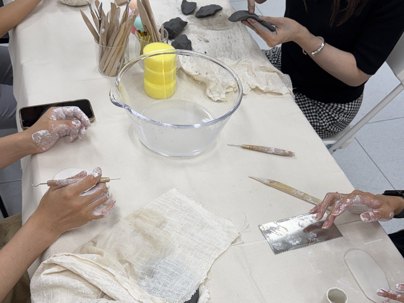 Hands shaping clay at the table — Material Lab × AI Archiving, July 15, 2026