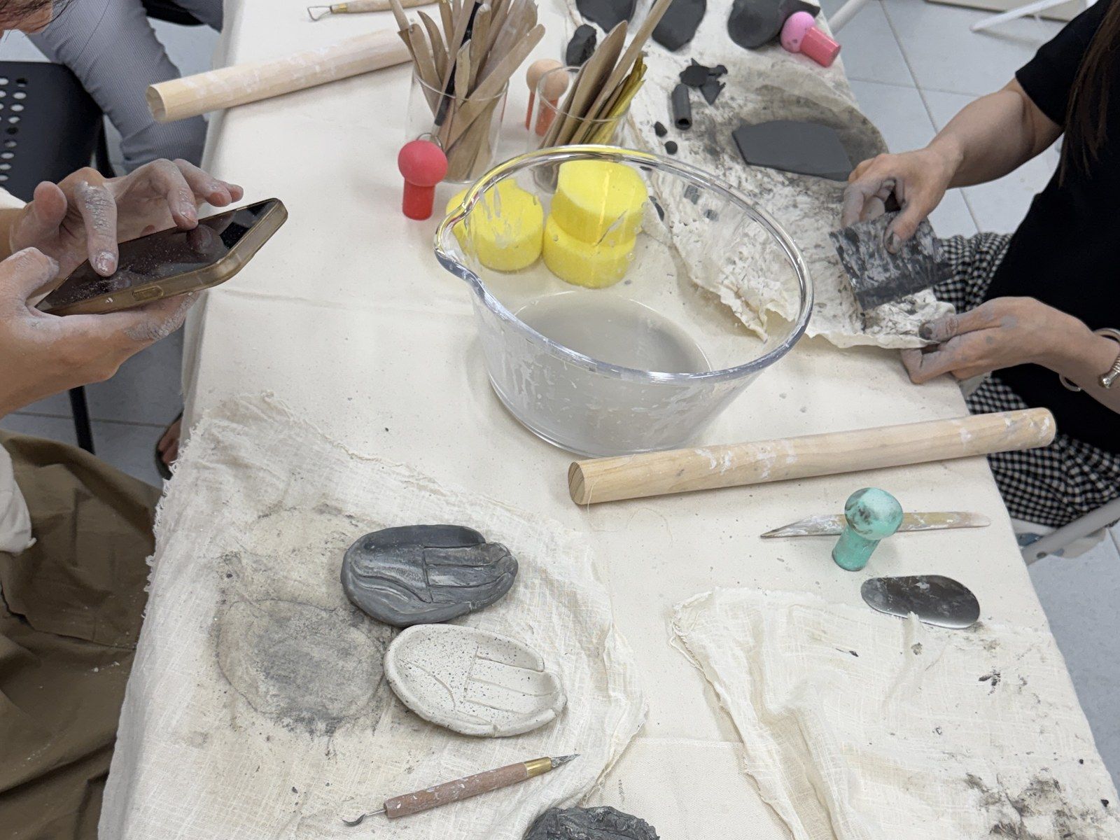 Participants shaping clay at the long table — Material Lab × AI Archiving, July 15, 2026
