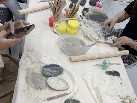 Participants shaping clay at the long table — Material Lab × AI Archiving, July 15, 2026