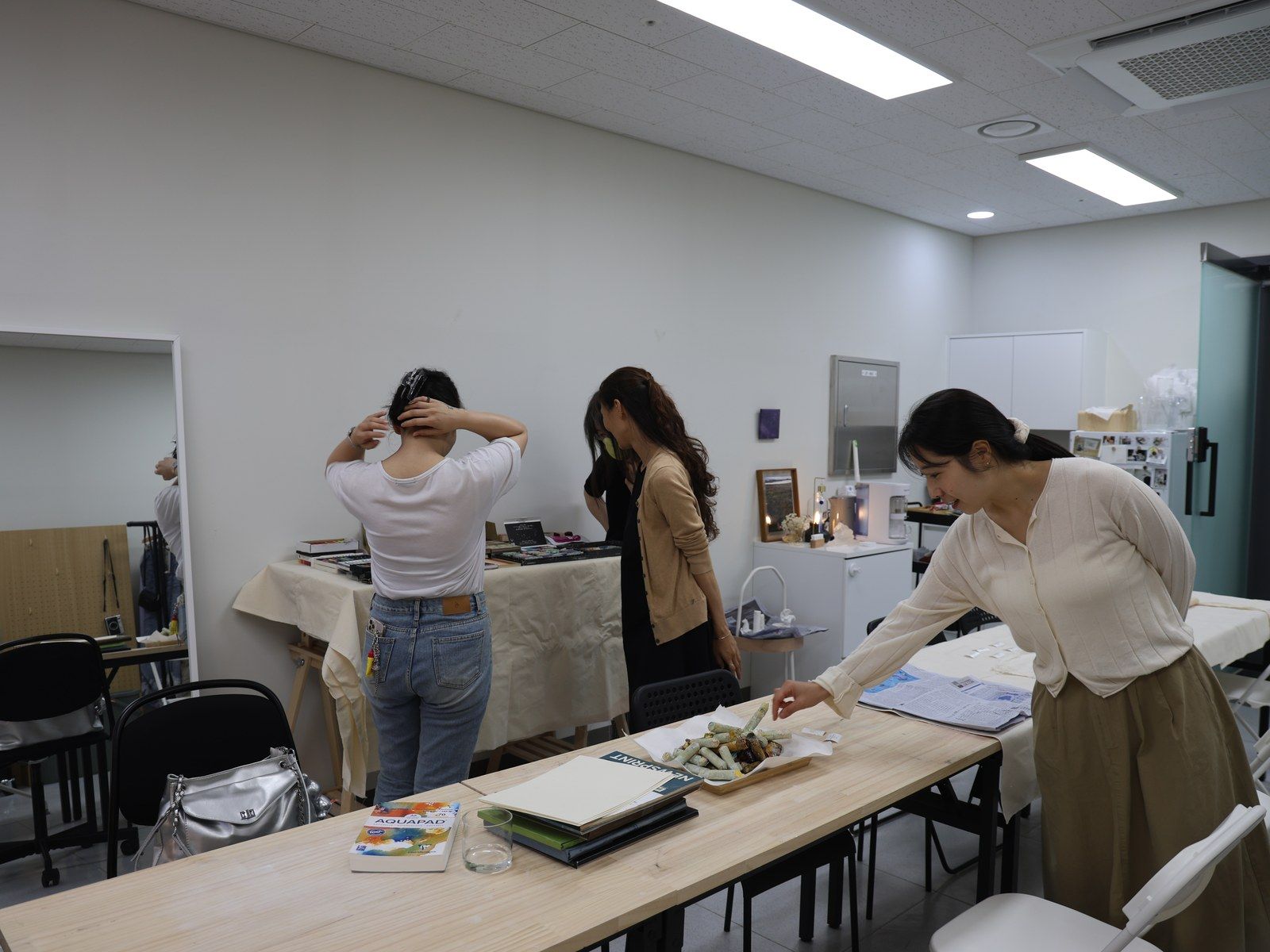 Participants and the facilitator setting up the studio before the session — Material Lab × AI Archiving, July 15, 2026