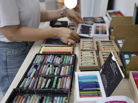 Hands selecting pastel colors from open pastel sets — Material Lab × AI Archiving, July 15, 2026