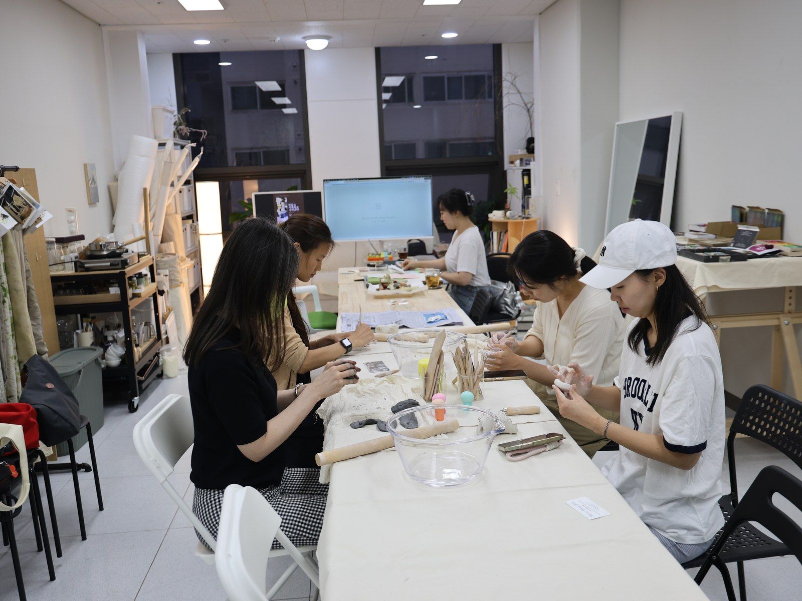 Participants seated side by side working at the long table — Material Lab × AI Archiving, July 15, 2026