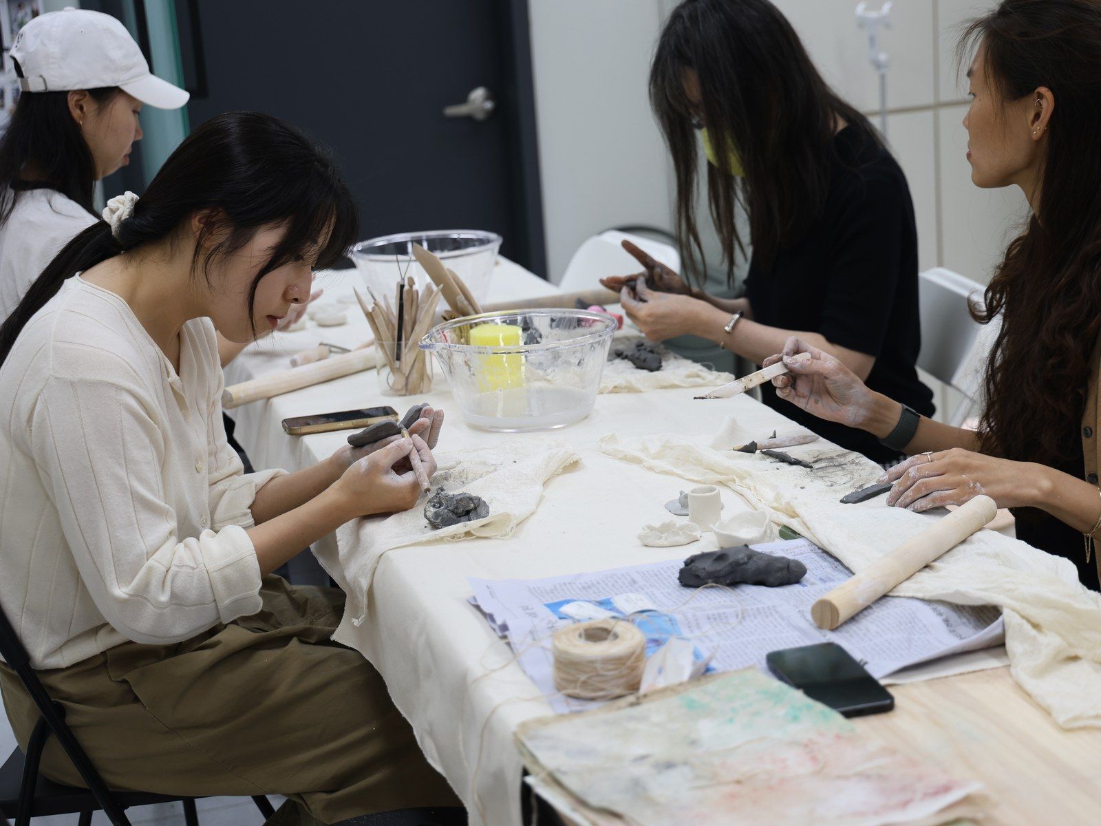 A participant photographing a pastel portrait with a phone — Material Lab × AI Archiving, July 15, 2026