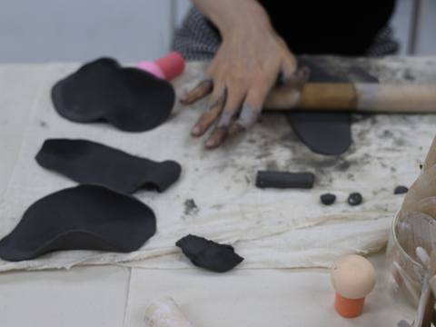 Hands shaping black clay with a rolling pin — Material Lab × AI Archiving, July 15, 2026