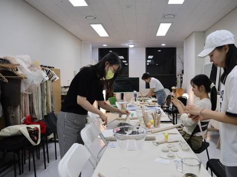 A wide view of participants working, one wearing a mask — Material Lab × AI Archiving, July 15, 2026